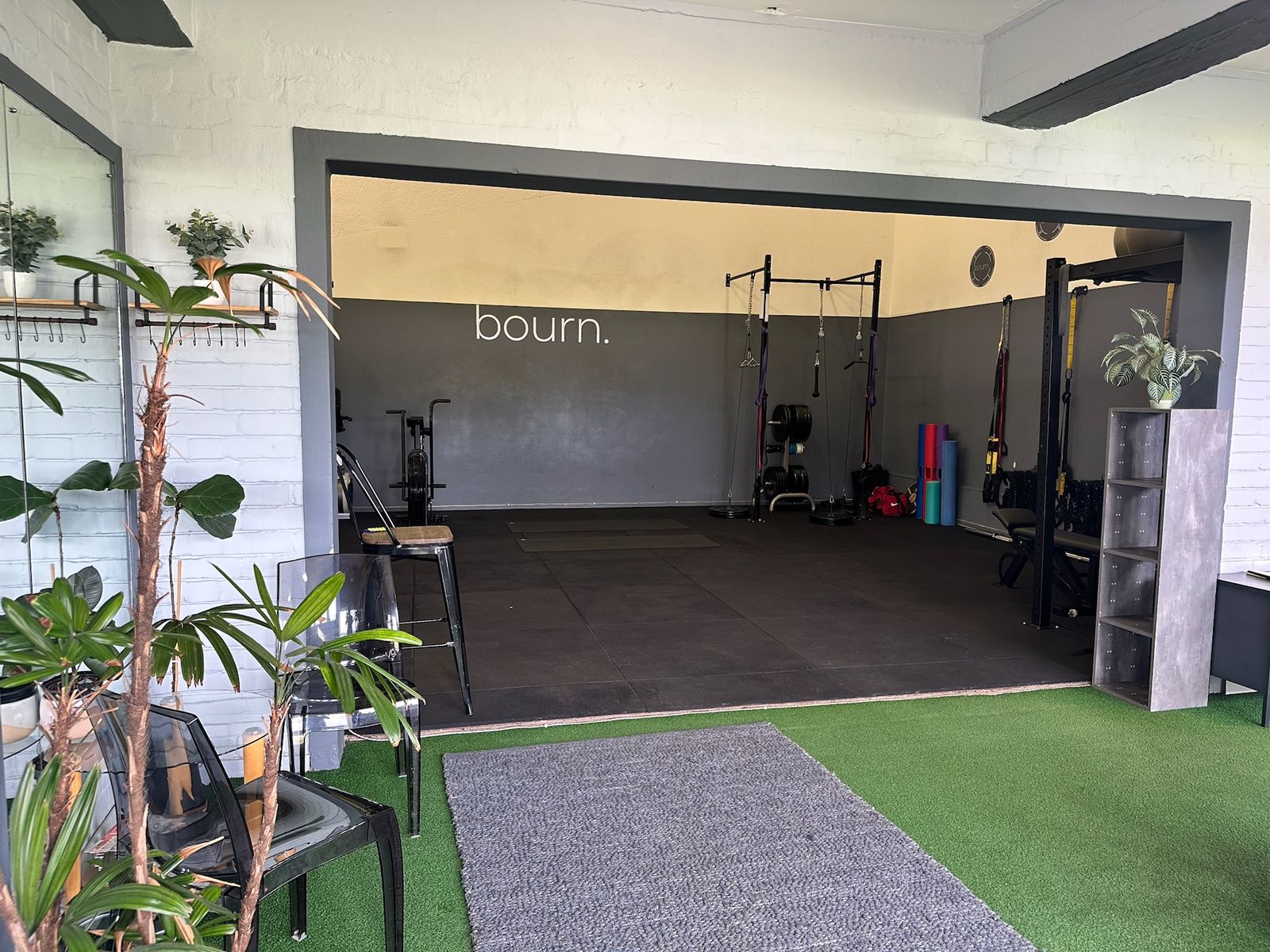 The studio seen from the entrance, looking in across artificial turf and seating.